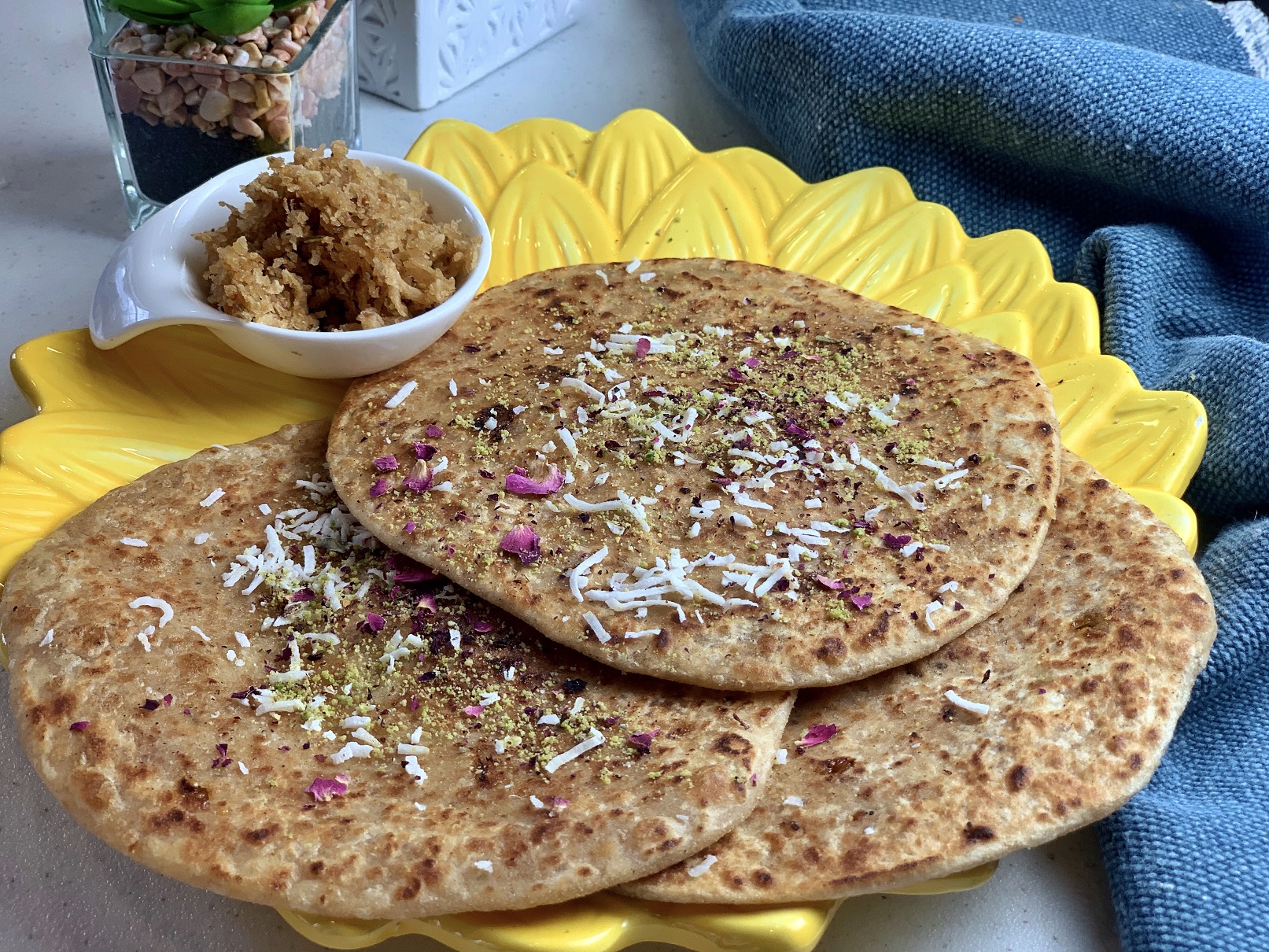 Coconut Jaggery Paratha (Nariyal Aur Gur Ka Paratha) - A quick fix for those quarantine sweet tooth pangs, this sweet coconut-jaggery stuffed Indian flatbread is flavored with cardamom, saffron and rosewater. It’s a perfect way to enjoy a traditional sweet without needing to indulge!