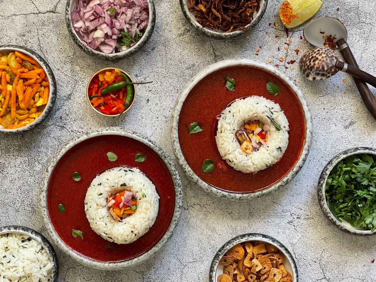 Tomato Beetroot Rasam with Coconut Rice - topped off with crunchy peanuts, fresh onions, crispy garlic and spicy namkeen to provide a burst of amazing flavors that take this traditional south indian soup to the next level!